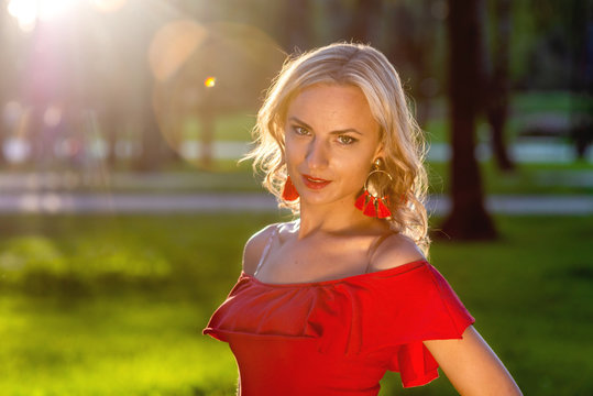 A portrait of a young blonde woman in the last rays of the sun - image