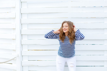 The girl in front of a white wall copy space