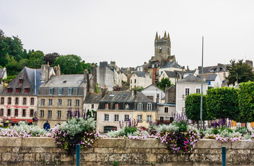 Fototapeta premium Notre-Dame de l'Assumption above Quai Brizeux at Quimperle. Finistere, Brittany, France