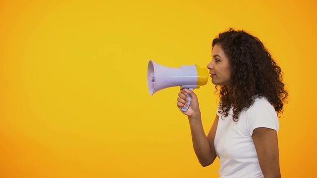 African-American woman with megaphone announcing sensation news, shop discounts