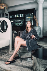 Beautiful woman relaxing in bathrobe in spa center