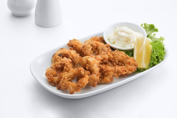 close up view of nice fried squid rings on white background.