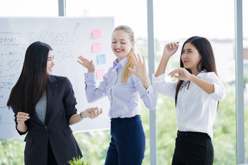 Picture of happy business team celebrating victory in office.Party with friends. Businesswoman cheerful relaxing and dancing in office.