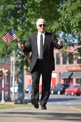 Adult Male Politician Portrait With Usa Flag Walking On Sidewalk