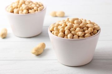 raw peeled peanuts on a light background