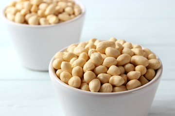 raw peeled peanuts on a light background