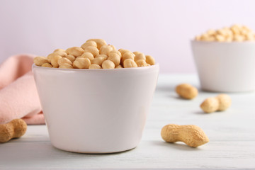 raw peeled peanuts on a light background