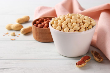 raw peeled peanuts on a light background