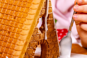 Familiy building a sweet ginger bread house