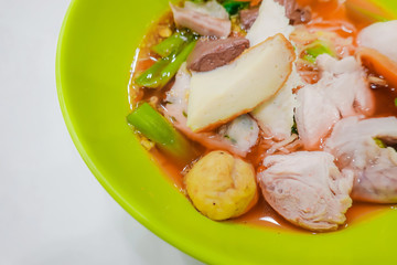 Yentafo noodles contain moning glory,squid,meat ball,fish ball and pink soup put on the table, Thailand Street Food .