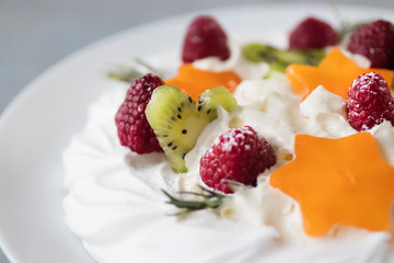 Dessert Pavlova. Cake with whipped cream and fresh berries.