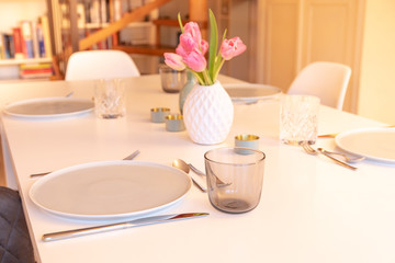 Decorated Table with Tulips, Plates and Glasses