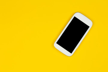 smart phone on yellow background with copy space