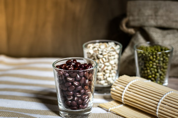 Cereals in glass cups placed on a wooden background