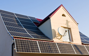 Fototapeta premium Solar panels on red tin roof