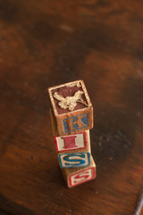 Word kiss Spelled with Old Vintage antique Wooden Toy Block Letters