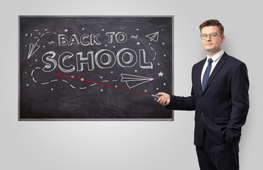 Handsome young teacher with laser pointer teaching 
