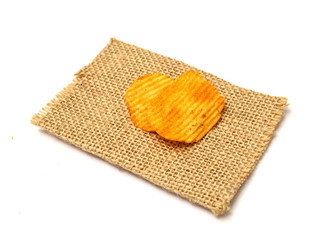 potato chips spiced with hot chili pepper on small jute bag