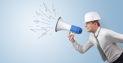 Fototapeta premium Young architect constructor yelling with megaphone and copyspace 