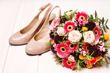 Wedding bouquet and a pair of stilettos.