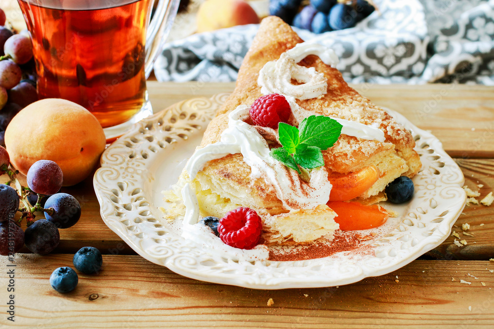 Wall mural delicious puff pastry cakes filled with cheese and fruits.