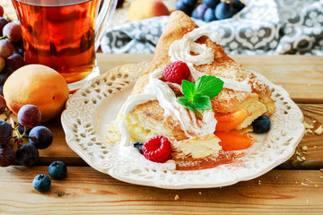 Delicious puff pastry cakes filled with cheese and fruits.