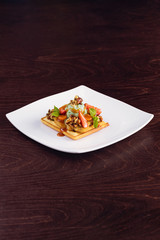 Dessert waffle with ice cream, banana and strawberries, nuts.