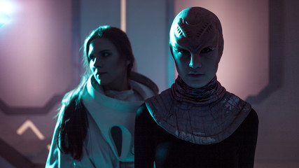 Woman and an alien look at each other. Contact with other civilizations.