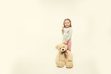 children in winter pajamas hugging each other © Mariia