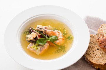 Seafood soup recipe. Home made cooking. Plate of assorted shellfish with brown bread.