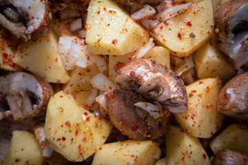 Simply, fast and tasty vegetarian dish from potato, brown champignon mushroom and onion with spices, ready for baking.