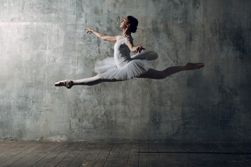 Ballerina female. Young beautiful woman ballet dancer, dressed in professional outfit, pointe shoes...