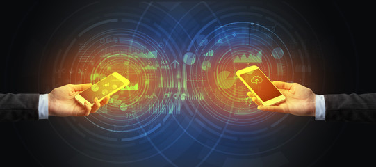 Close up of two smartphones syncing business data