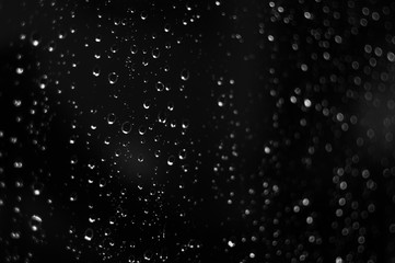 Droplets of water on black glass background