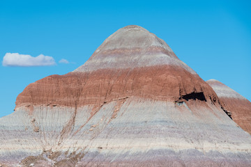 Colorful desert mountain peak with red, orange, and purple strata in Petrified Forest National...