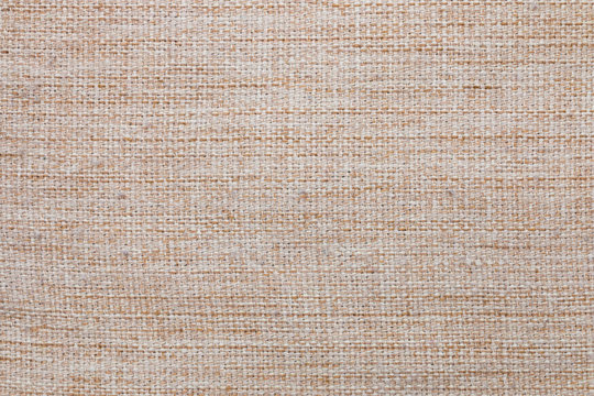 Fabric texture. Linen cloth close-up photo. Beige burlap or woven textile background