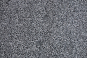 Gray granite texture. Subtle grain stone background. Dark rough granitic wall closeup