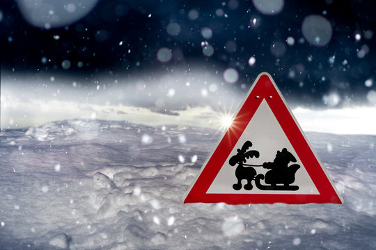 traffiic sign with Santa Claus - winter driving - risk of snow and ice 