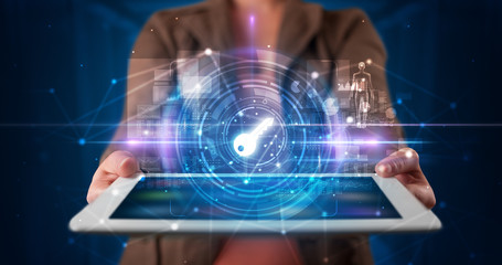 Hand holding tablet with online security and data protection concept
