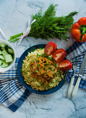 Turkish bulgur pilaf with meatballs and greens. Tasty homemade food close up.