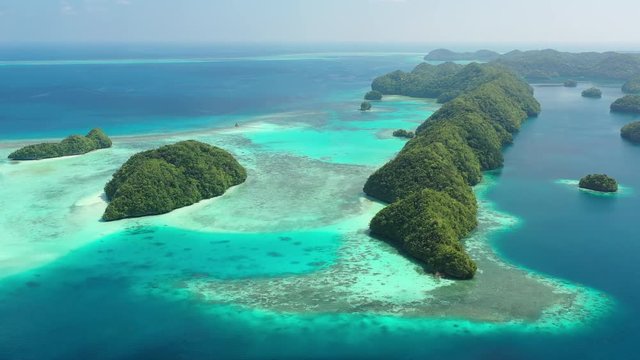 Aerial view of South Rock Islands (Chelbacheb), lush green islets around Mecherchar island, seascape with colorful coral reefs and tropical lagoons - landscape panorama of Micronesia from above, Palau