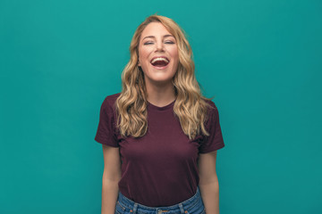 Portrait of a beautiful smiling woman on blue background.