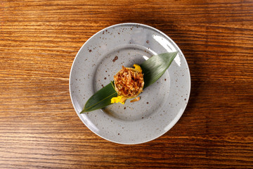 dish of  Ratotoue with leaf on back wood background 
