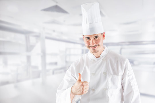 Chef professional in restaurant kitchen showing gestue thumbs up