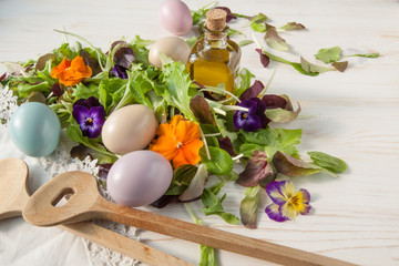 Lettuce and flower salad on woody white background spring, easter
