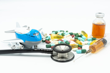 Toy airplane with black stethoscope and assorted medicine imply medical tourism