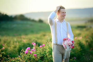 beautiful gorgeous bride and stylish handsome groom, rustic couple in a rose field