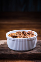 Baked apple with oats and crunch in ceramic pot