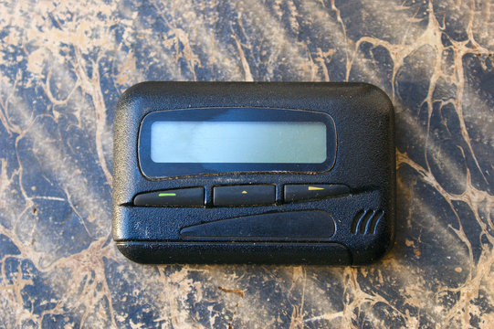 pagers, old vintage beeper. pager on the antique book
