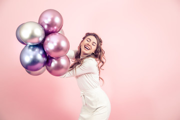 Young girl with balls on a colored background